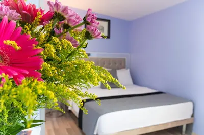 a bedroom with a bed with a bouquet of flowers at Primero Hotel in Istanbul