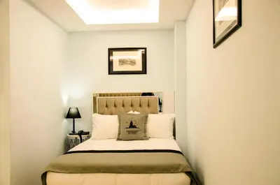 a bedroom with a bed with white walls and a skylight at Primero Hotel in Istanbul