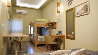 a room with a bed and a desk and a bunk bed at Second Home Suites in Istanbul
