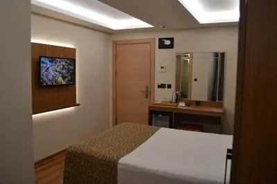 a bedroom with a bed and a bathroom with a sink at Gumus Palace Gungoren in Istanbul