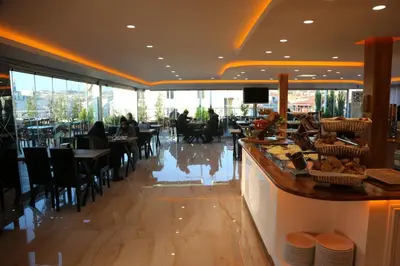 a restaurant with a bar and people sitting at tables at Gumus Palace Gungoren in Istanbul