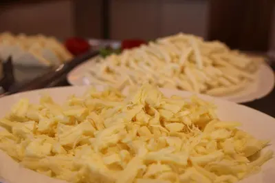 a plate of food with cheese on a table at Gumus Palace Gungoren in Istanbul