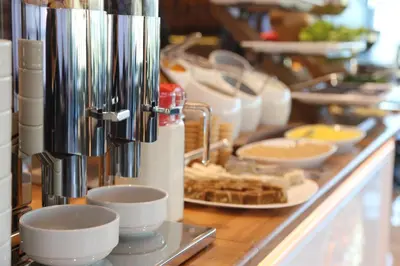 a counter with cups and plates of food on at Gumus Palace Gungoren in Istanbul