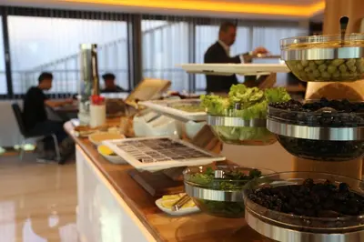 a buffet line in a restaurant with fruit and vegetables at Gumus Palace Gungoren in Istanbul