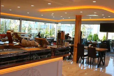 a restaurant with tables and chairs in a building at Gumus Palace Gungoren in Istanbul