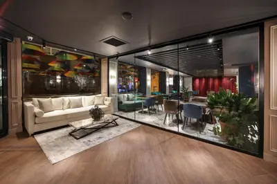 a living room with a couch and a table and chairs at Concept Nisantasi Hotels & Spa in Istanbul