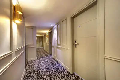a corridor with a hallway with a door and a tile floor at Concept Nisantasi Hotels & Spa in Istanbul