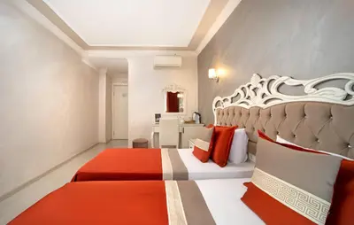 a bedroom with a bed with red and white pillows at Deluxe Newport Hotel - Old City in Istanbul