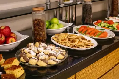 a buffet with plates of food and bowls of fruit at Deluxe Newport Hotel - Old City in Istanbul
