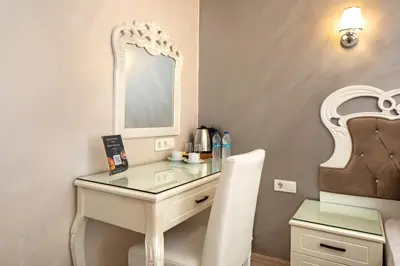 a dressing table with a mirror and a chair at Deluxe Newport Hotel - Old City in Istanbul
