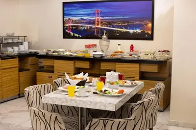 a dining room with a table with food on it at Deluxe Newport Hotel - Old City in Istanbul