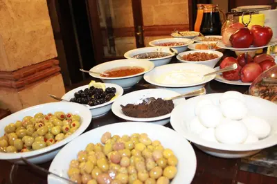 a table topped with bowls of different types of food at Hotel SultanHill in Istanbul