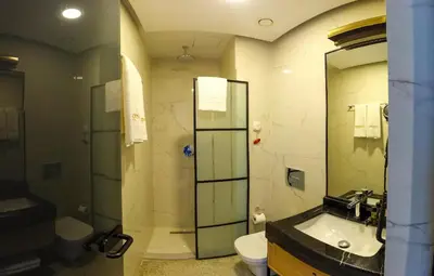 a bathroom with a sink and a toilet and a shower at Maroon Tomtom in Istanbul