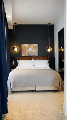 a bedroom with a large bed with a blue wall at Maroon Tomtom in Istanbul