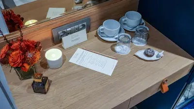 a table with plates and cups and candles on it at Maroon Tomtom in Istanbul