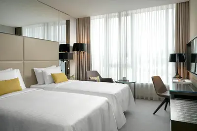 a hotel room with two beds and a window at Centro Westside by Rotana in Istanbul