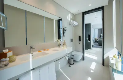 a bathroom with a sink and a toilet and a mirror at Centro Westside by Rotana in Istanbul