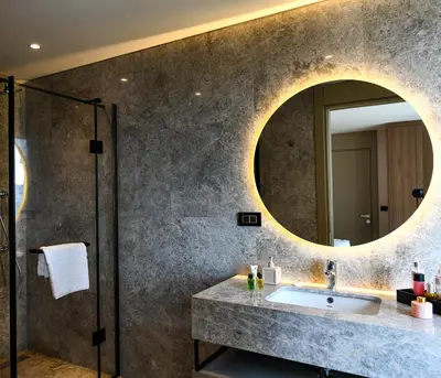 a bathroom with a sink and a mirror at WestSide Residences by Rotana in Istanbul