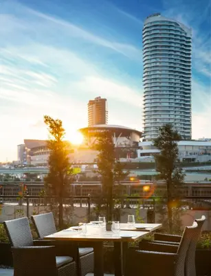 a table with chairs and a view of a city at WestSide Residences by Rotana in Istanbul