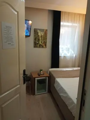 a bedroom with a bed and a small table at TAKSİM LİFE HOUSE in Istanbul