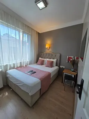 a bedroom with a large bed and a window at TAKSİM LİFE HOUSE in Istanbul