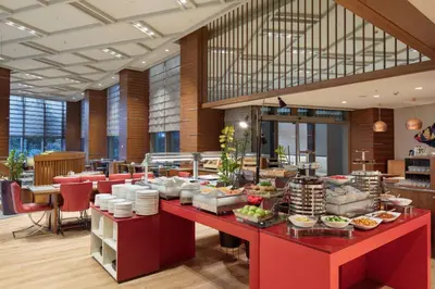 a buffet line in a restaurant with food on display at Hampton By Hilton Bursa in Bursa