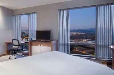 a hotel room with a bed and a large window at Hampton By Hilton Bursa in Bursa