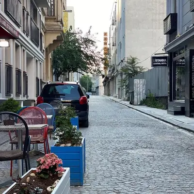 a car parked on a street with chairs and tables at Hotel Queens Land in Istanbul
