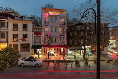 a car parked in a parking lot in front of a building at Charm Hotel in Istanbul