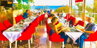 a group of people sitting at tables in a restaurant at Charm Hotel in Istanbul