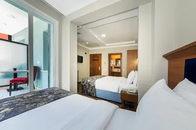 a hotel room with two beds and a window at Aristocrat Hotel in Istanbul