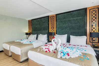 two beds in a hotel room with flowers on them at Aristocrat Hotel in Istanbul