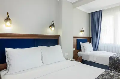 a hotel room with two beds and a window at Aristocrat Hotel in Istanbul