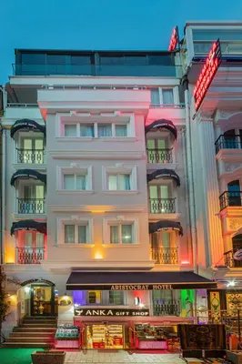 a large white building with a restaurant in front of it at Aristocrat Hotel in Istanbul