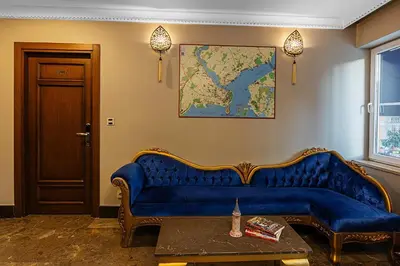 a blue couch in a room with a map on the wall at Aristocrat Hotel in Istanbul