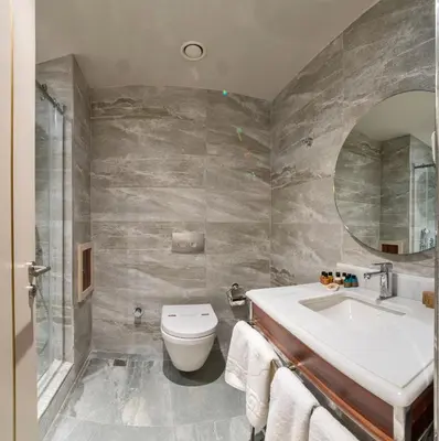 a bathroom with a sink toilet and a mirror at Golden Royal Hotel & SPA in Istanbul