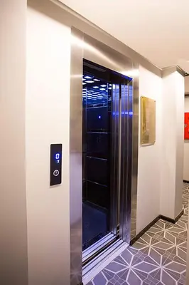 a elevator with a glass door in a building at Long Stay İstanbul Residence in Istanbul