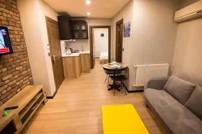 a living room with a couch and a table at Long Stay İstanbul Residence in Istanbul