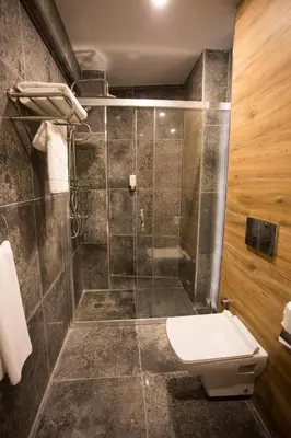 a bathroom with a toilet and a shower at Long Stay İstanbul Residence in Istanbul