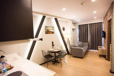 a kitchen and living room with a table and a couch at Long Stay İstanbul Residence in Istanbul