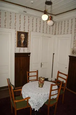 a dining room with a table and a portrait of a man at Yeşilköy Airport Hotel in Istanbul
