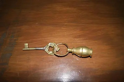 a metal key on top of a wooden table at Yeşilköy Airport Hotel in Istanbul