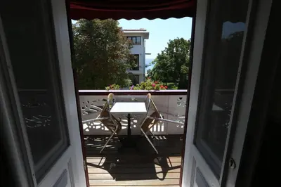 an open door with a table and chairs on a balcony at Yeşilköy Airport Hotel in Istanbul