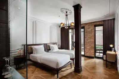 two beds in a room with two windows at Georges Hotel Galata in Istanbul