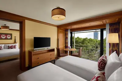a hotel room with two beds and a television at Divan Istanbul in Istanbul