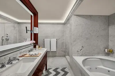 a white bathroom with a tub and a sink at Divan Istanbul in Istanbul