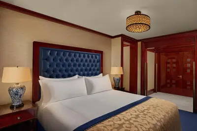 a bedroom with a large bed with a blue headboard at Divan Istanbul in Istanbul