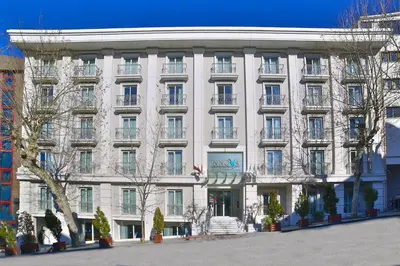 a large white building with trees in front of it at Innova Sultanahmet Istanbul in Istanbul
