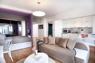 a living room with a couch and a kitchen at Nuru Ziya Residences in Istanbul