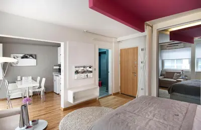 a bedroom with a bed and a living room at Nuru Ziya Residences in Istanbul